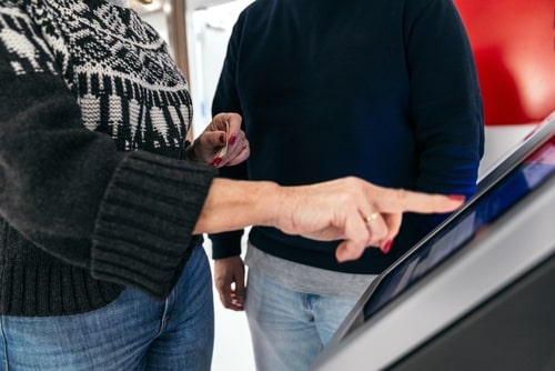 patient using check in healthcare kiosk